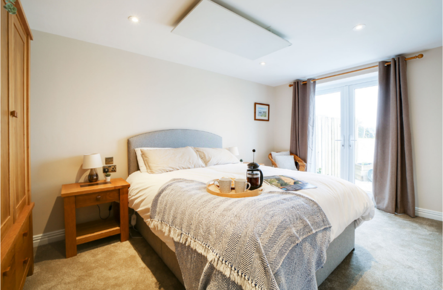 Interior view of The Tractor Shed bedroom at Trewena, a modern Falmouth holiday cottage with a private patio and surrounded by peaceful Cornish countryside.