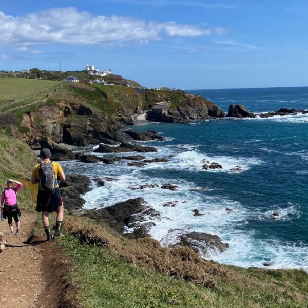 A breathtaking view of Lizard Point, the southernmost tip of mainland Britain, with rugged cliffs and the Atlantic Ocean stretching to the horizon.