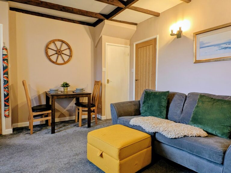A spacious and inviting living room and dining area at Little Avalon cottage.